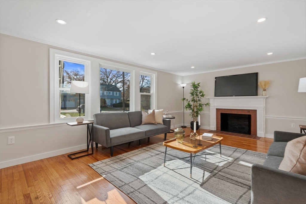 6 Puritan Lane Dedham, MA 02026 - Photo 12 of 41 a living room with furniture a flat screen tv and a fireplace