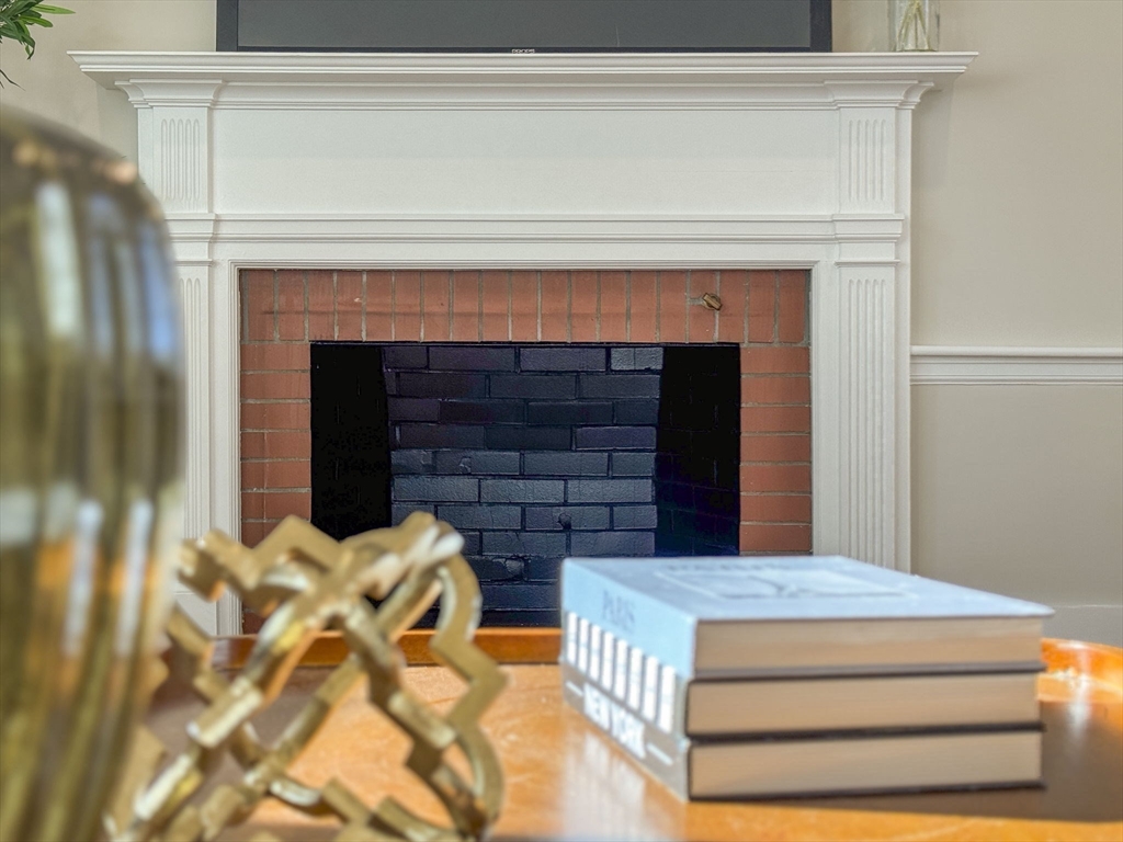 6 Puritan Lane Dedham, MA 02026 - Photo 13 of 41 a bedroom with a bed and a fireplace