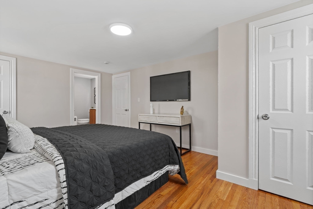 6 Puritan Lane Dedham, MA 02026 - Photo 20 of 41 a bedroom with a bed and a flat screen tv