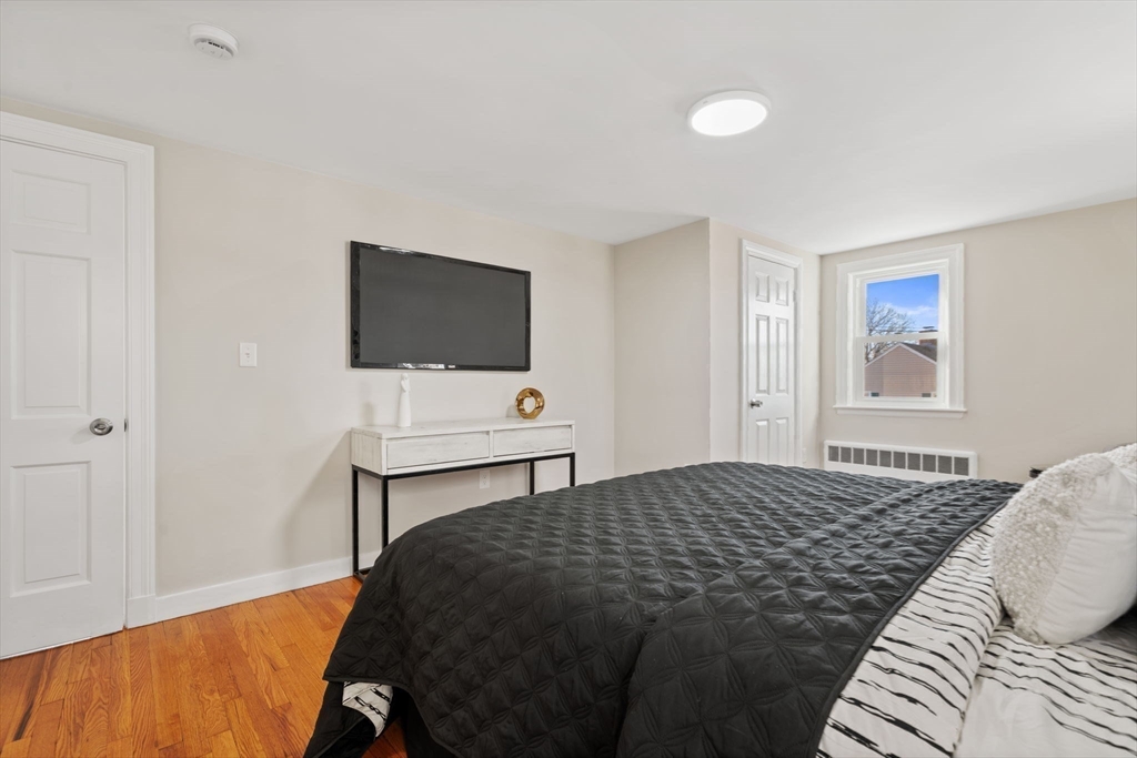 6 Puritan Lane Dedham, MA 02026 - Photo 21 of 41 a bedroom with a bed and a flat screen tv
