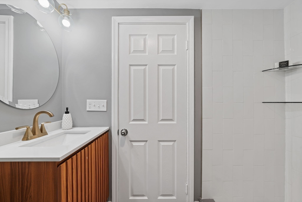 6 Puritan Lane Dedham, MA 02026 - Photo 22 of 41 a bathroom with a sink and a mirror