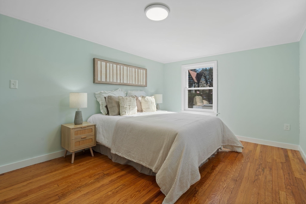 6 Puritan Lane Dedham, MA 02026 - Photo 25 of 41 a bedroom with a bed and a painting on the wall