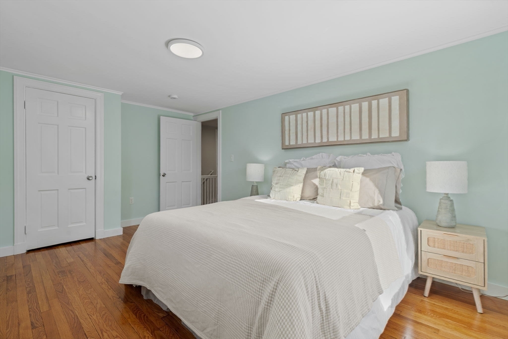6 Puritan Lane Dedham, MA 02026 - Photo 26 of 41 a bedroom with a bed and a night stand
