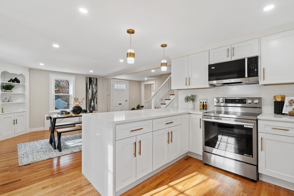 6 Puritan Lane Dedham, MA 02026 - Photo 3 of 41 a kitchen with stainless steel appliances white cabinets a sink and a stove