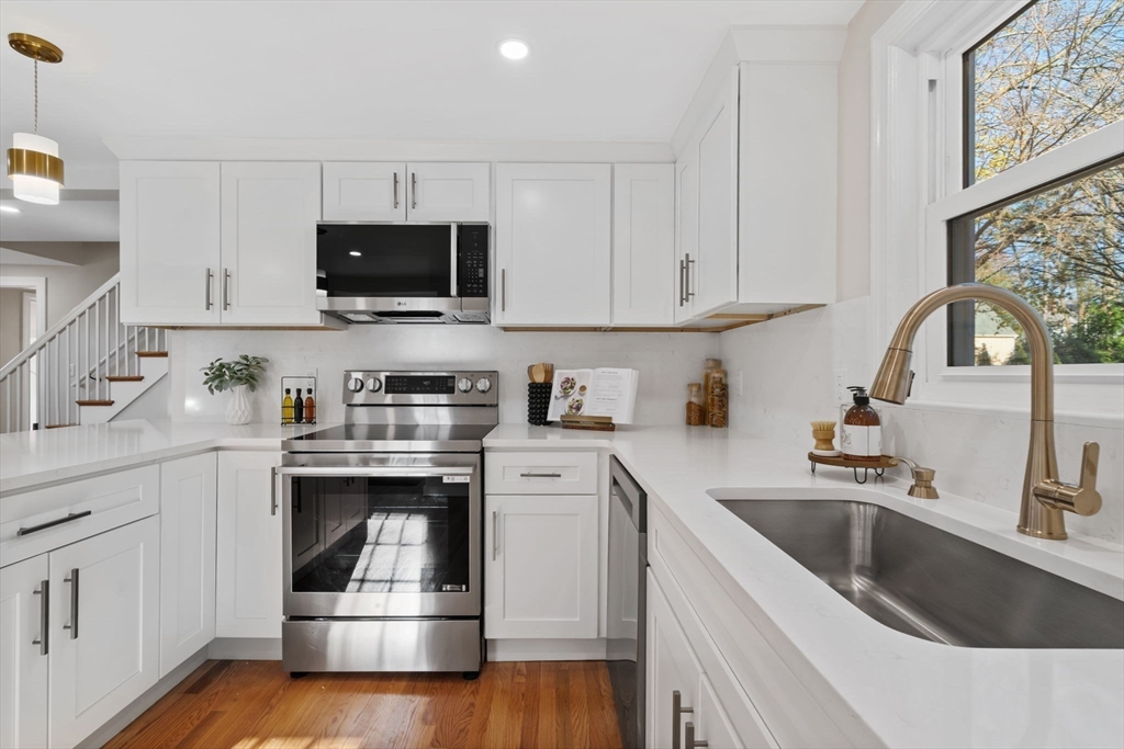 6 Puritan Lane Dedham, MA 02026 - Photo 4 of 41 a kitchen with white cabinets sink and stainless steel appliances