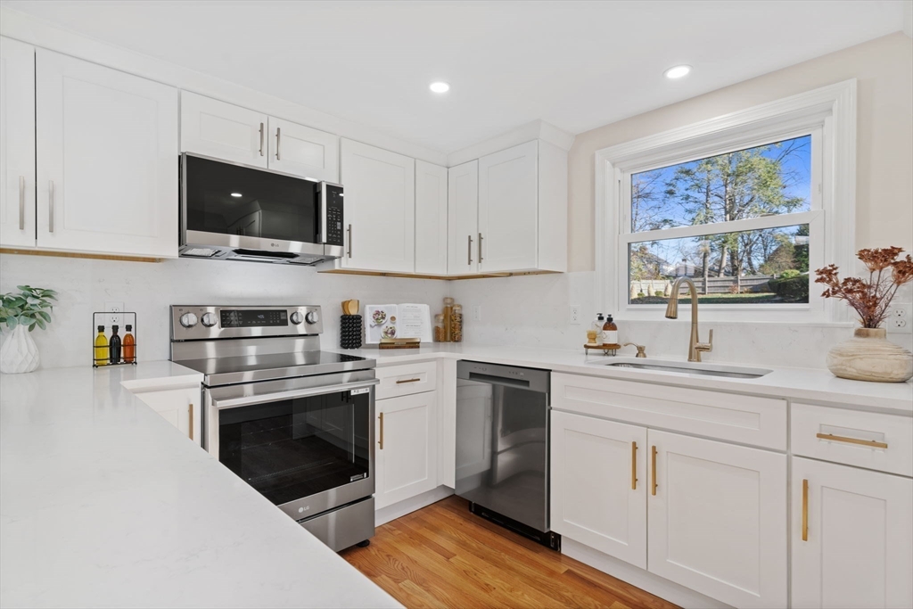 6 Puritan Lane Dedham, MA 02026 - Photo 5 of 41 a kitchen with cabinets stainless steel appliances and sink