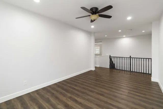 a kitchen with stainless steel appliances granite countertop a stove and a wooden floors