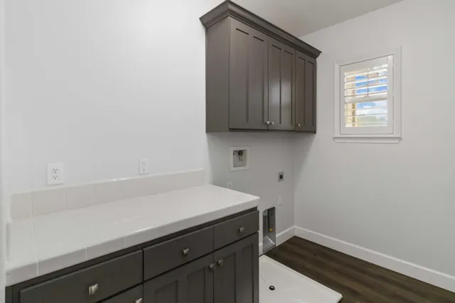 an empty room with a window and wooden floor