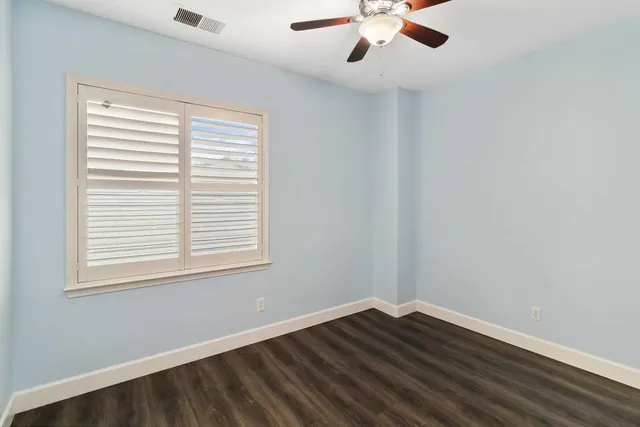 an empty room with wooden floor and closet