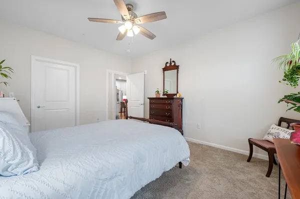 a spacious bedroom with a bed and a table in it