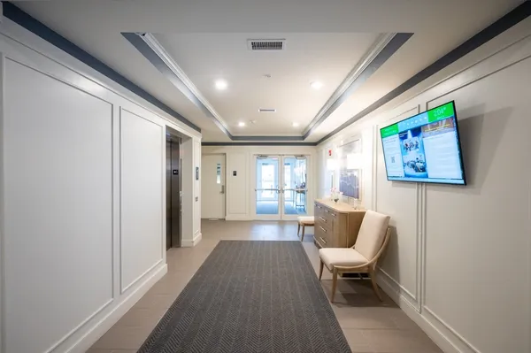 a living room with furniture and a entryway
