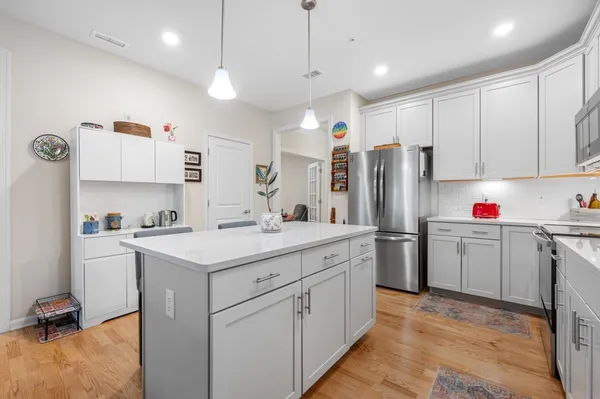 a kitchen with refrigerator sink and cabinets