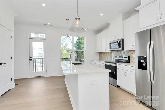 a kitchen with a sink stove and refrigerator