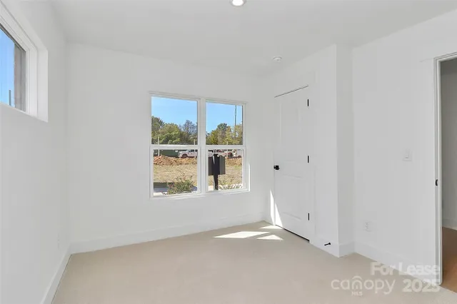 an empty room with a windows and closet