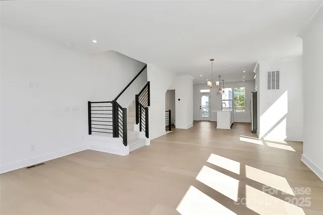 a view of an empty room with a kitchen