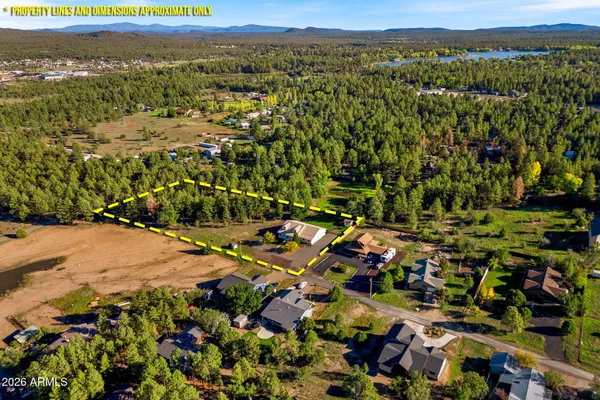 a view of a patio with table and chairs under an umbrella