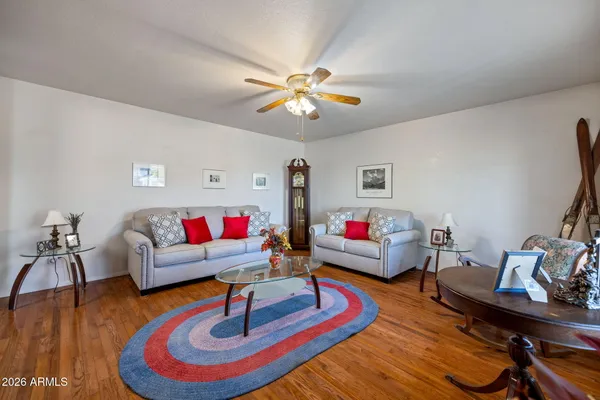 a living room with furniture and wooden floor