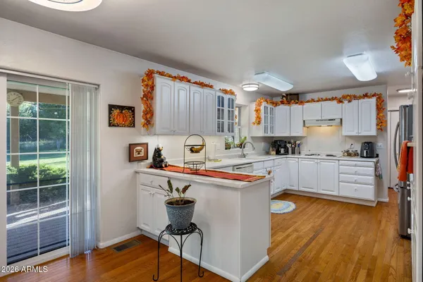 a kitchen with stainless steel appliances a stove a sink a refrigerator and cabinets
