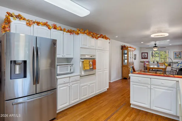 a kitchen with granite countertop a refrigerator and a stove top oven