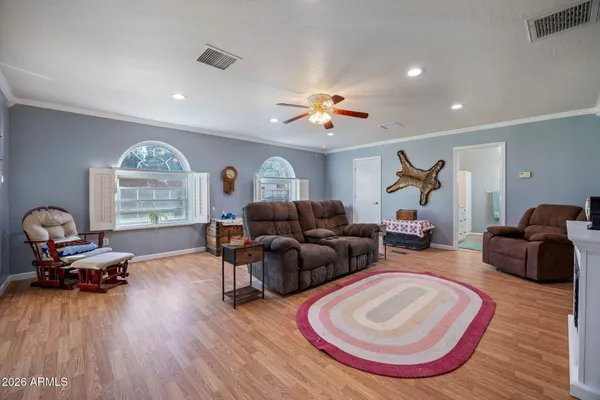 a living room with furniture and a wooden floor