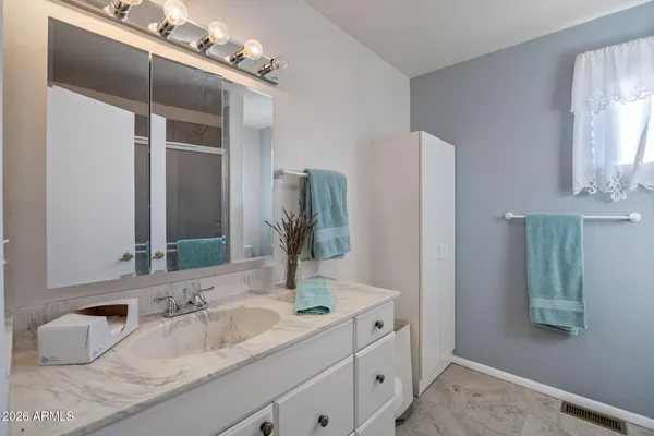 a bathroom with a double vanity sink and a mirror