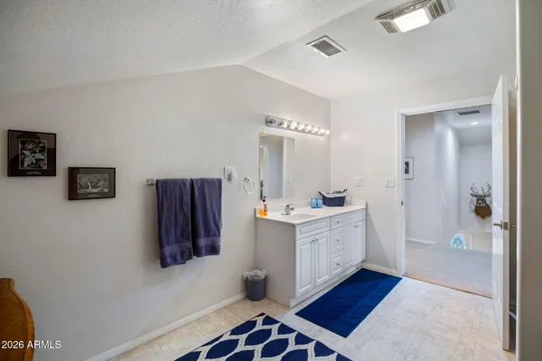 a bathroom with a double vanity sink and mirror