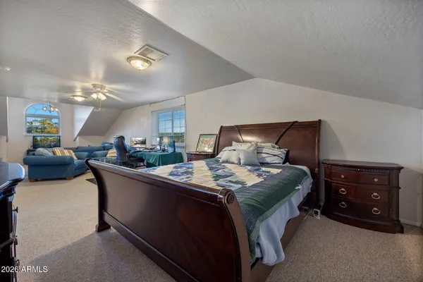 a living room with furniture and kitchen view