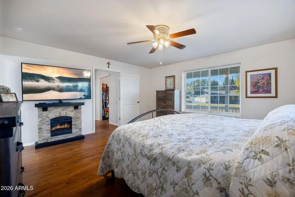a bathroom with a sink a toilet a large mirror and shower