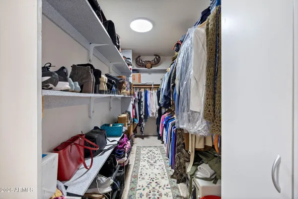 a view of a patio with table and chairs potted plants and palm trees