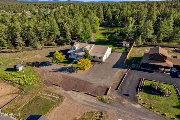 an aerial view of a houses with a yard