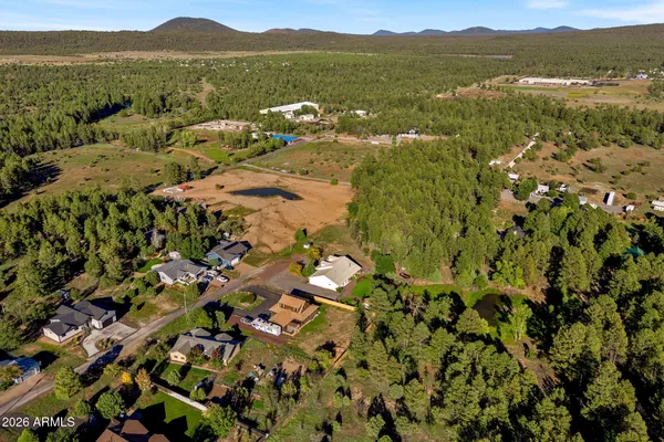 an aerial view of house with yard