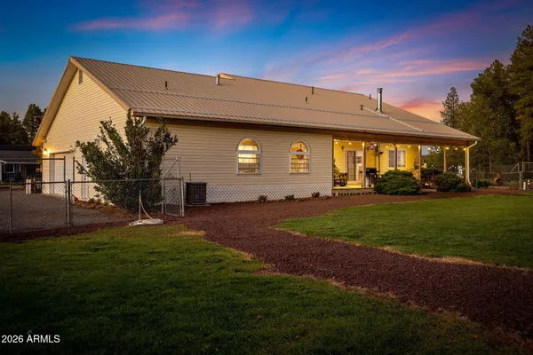 a view of a house with backyard and porch