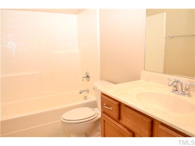 3517 Stonebend Loop Cary, NC 27518 - Photo 16 of 21 a bathroom with a sink a toilet and shower