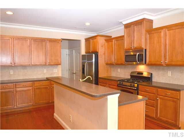 3517 Stonebend Loop Cary, NC 27518 - Photo 6 of 21 a kitchen with stainless steel appliances granite countertop a stove a sink dishwasher and a refrigerator