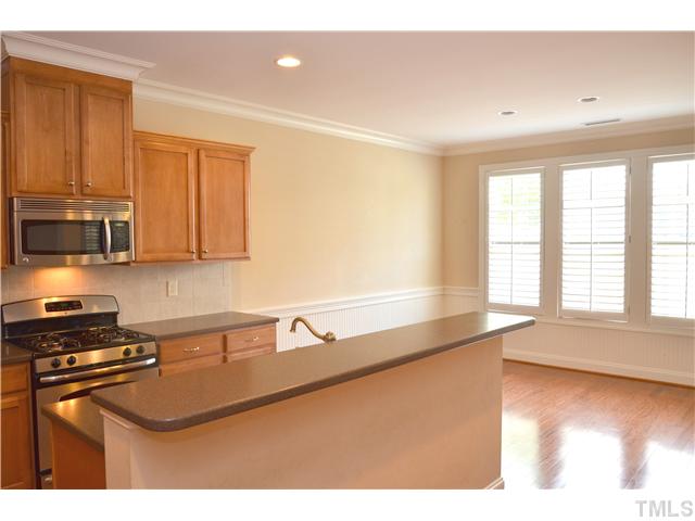 3517 Stonebend Loop Cary, NC 27518 - Photo 7 of 21 a kitchen with stainless steel appliances granite countertop a sink a stove and a microwave
