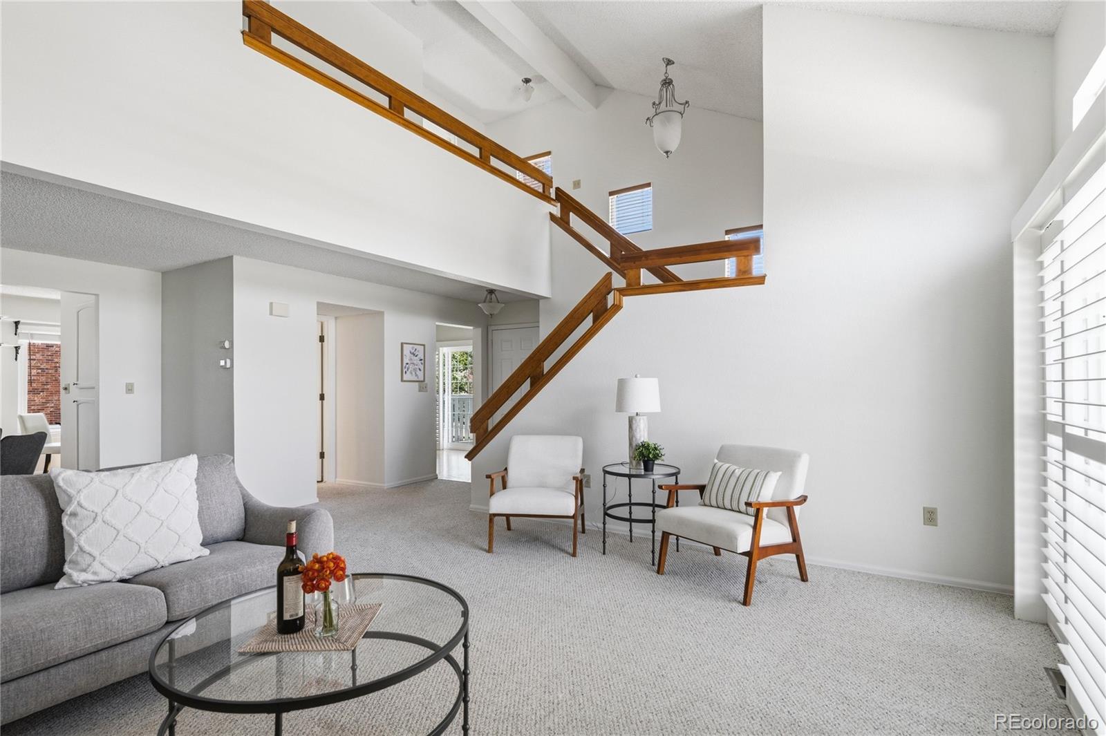 155 Blue Spruce Court Highlands Ranch, CO 80126 - Photo 5 of 29 a living room with furniture and stairs