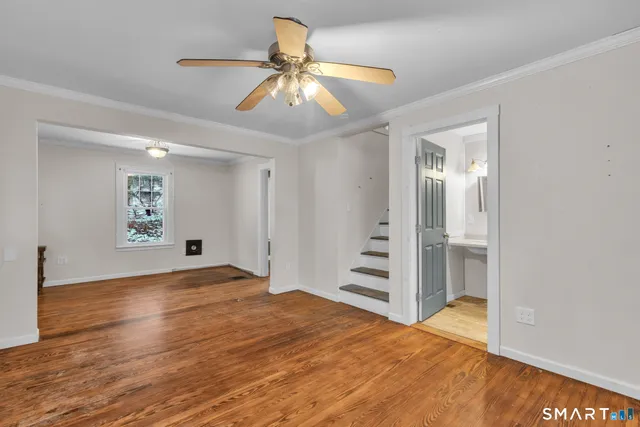 a view of empty room with wooden floor