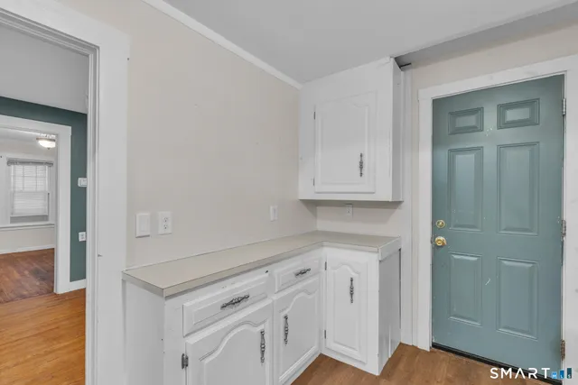 wooden floor with white cabinets