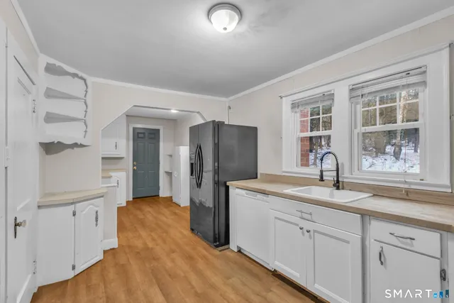 a kitchen with refrigerator and window