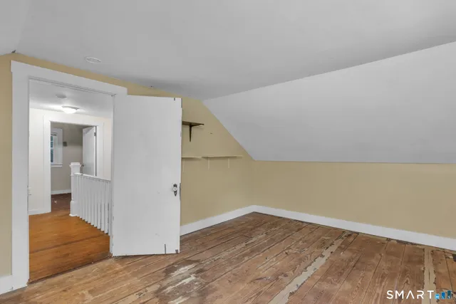 a view of hallway with wooden floor