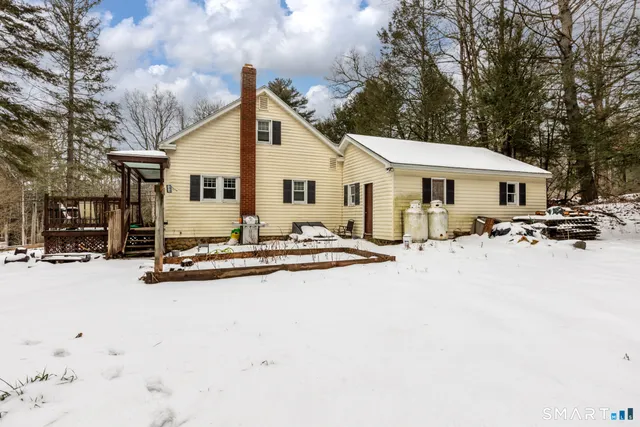 a view of a house with snow on the road