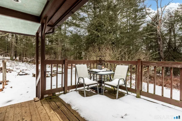 a view of balcony with chairs and wooden fence