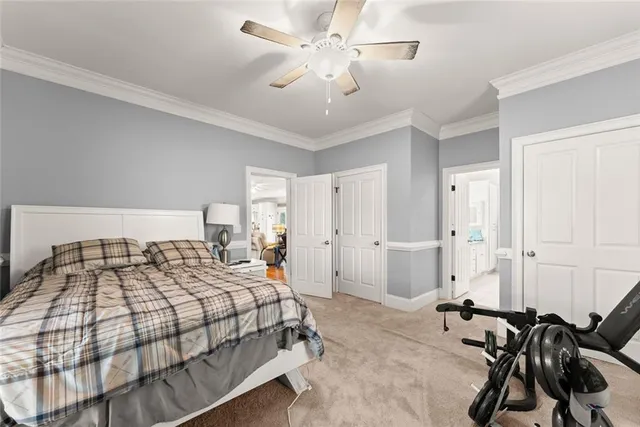 a bedroom with a bed and ceiling fan
