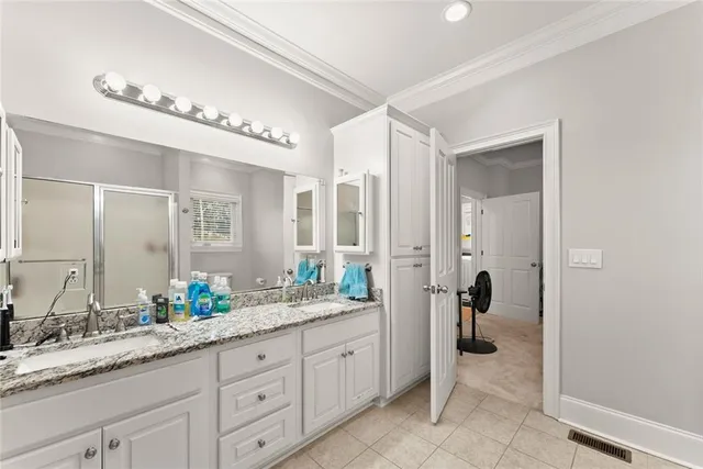 a spacious bathroom with a granite countertop sink mirror and shower