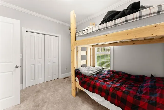 a bed sitting in a bedroom next to a window