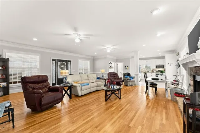 a living room with furniture a fireplace and wooden floor