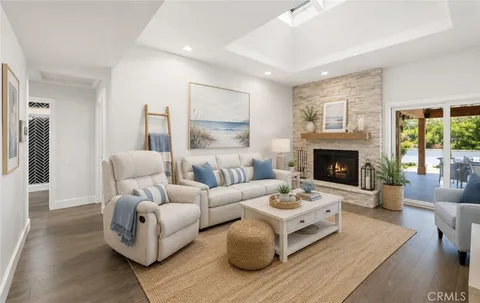 a living room with furniture fireplace and a large window