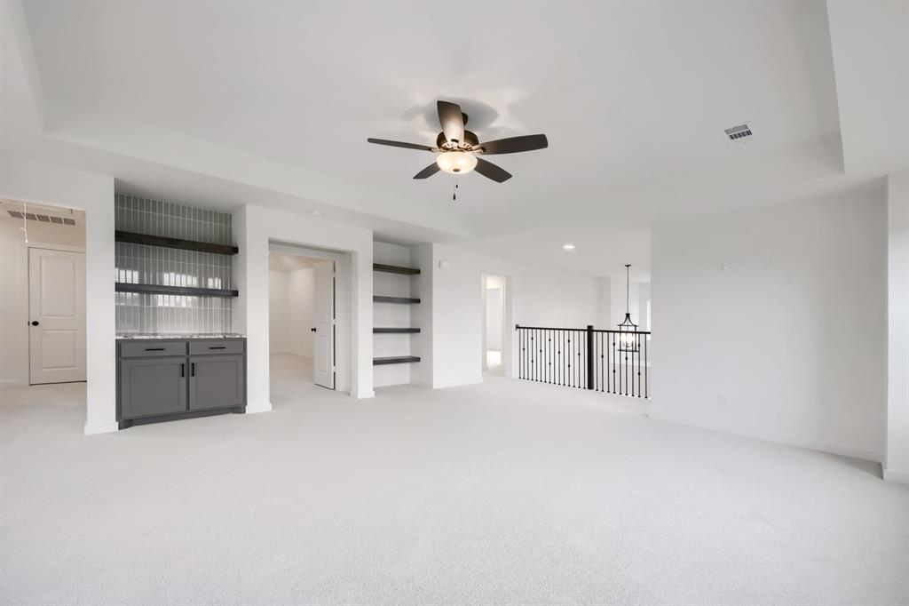 733 Red Cedar Road Haslet, TX 76052 - Photo 12 of 28 Spacious interior room featuring light-toned carpeting and a tray ceiling