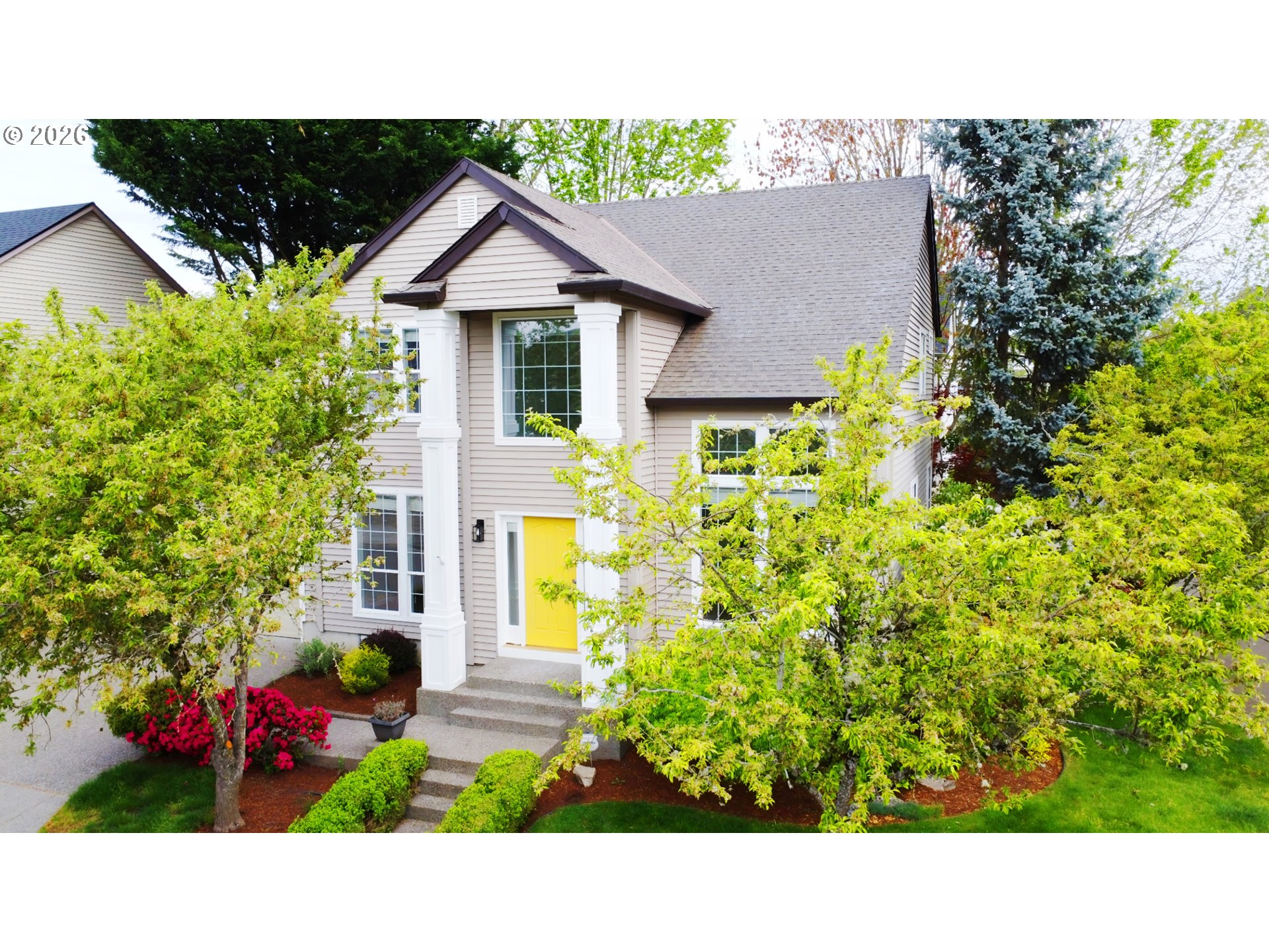 8911 Southwest Gravenstein Lane Tigard, OR 97224 - Photo 4 of 33 a picture of a house with a yard and potted plants