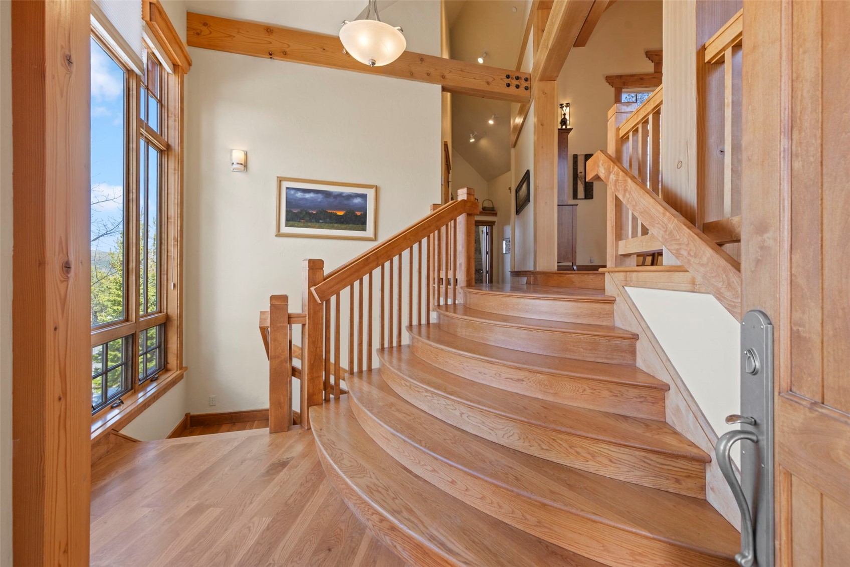 317 Timbertrail Road Breckenridge, CO 80424 - Photo 6 of 50 a view of staircase with lots of frames on wall and wooden floor